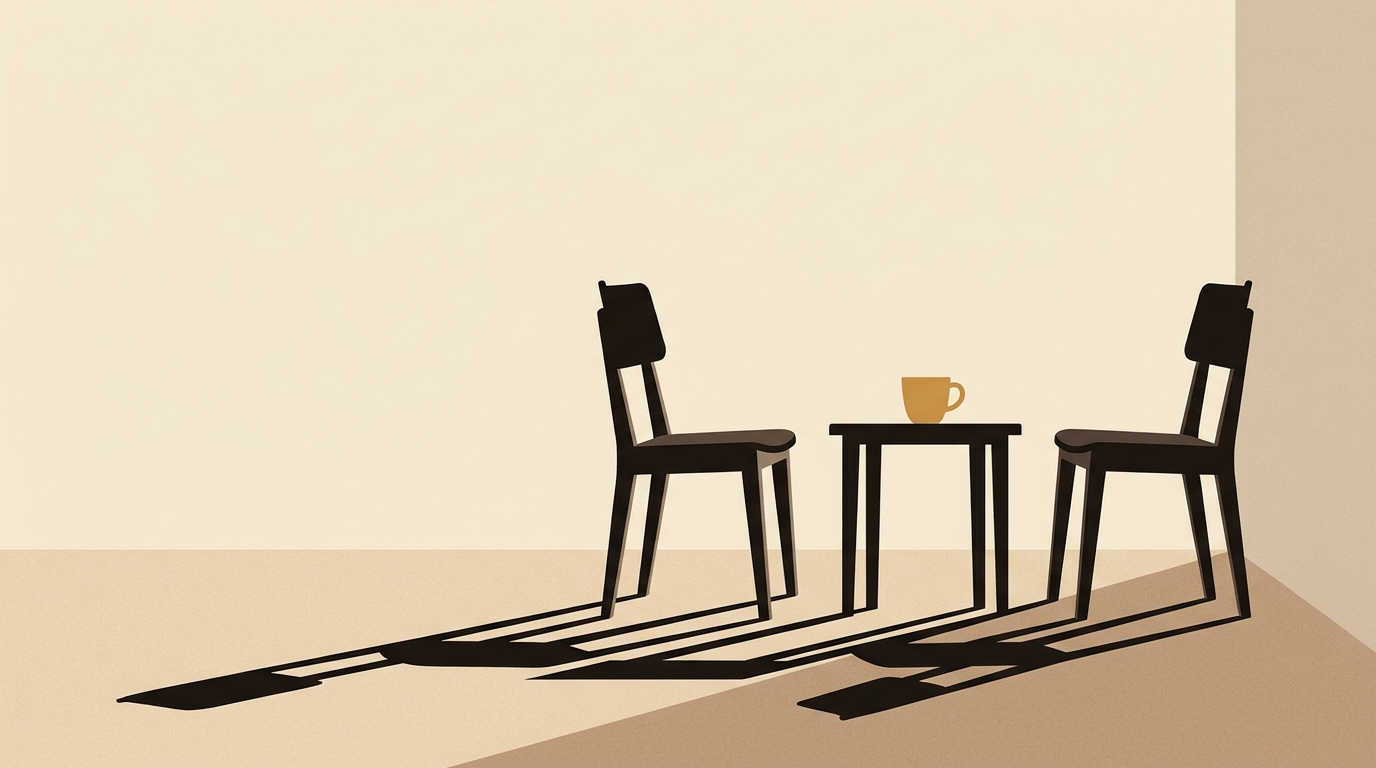 Deux chaises vides face à face autour d'une petite table, une tasse caramel posée entre elles
